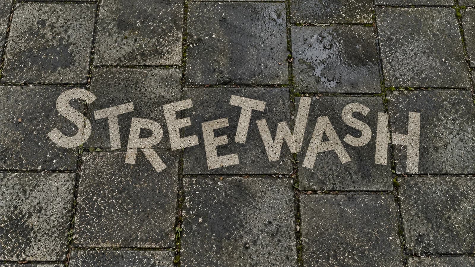 Clean reverse graffiti logo revealed on Amsterdam pavement